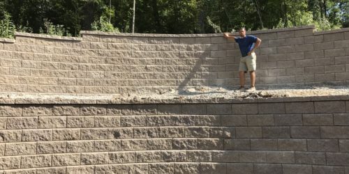 Expert posing with new retaining wall